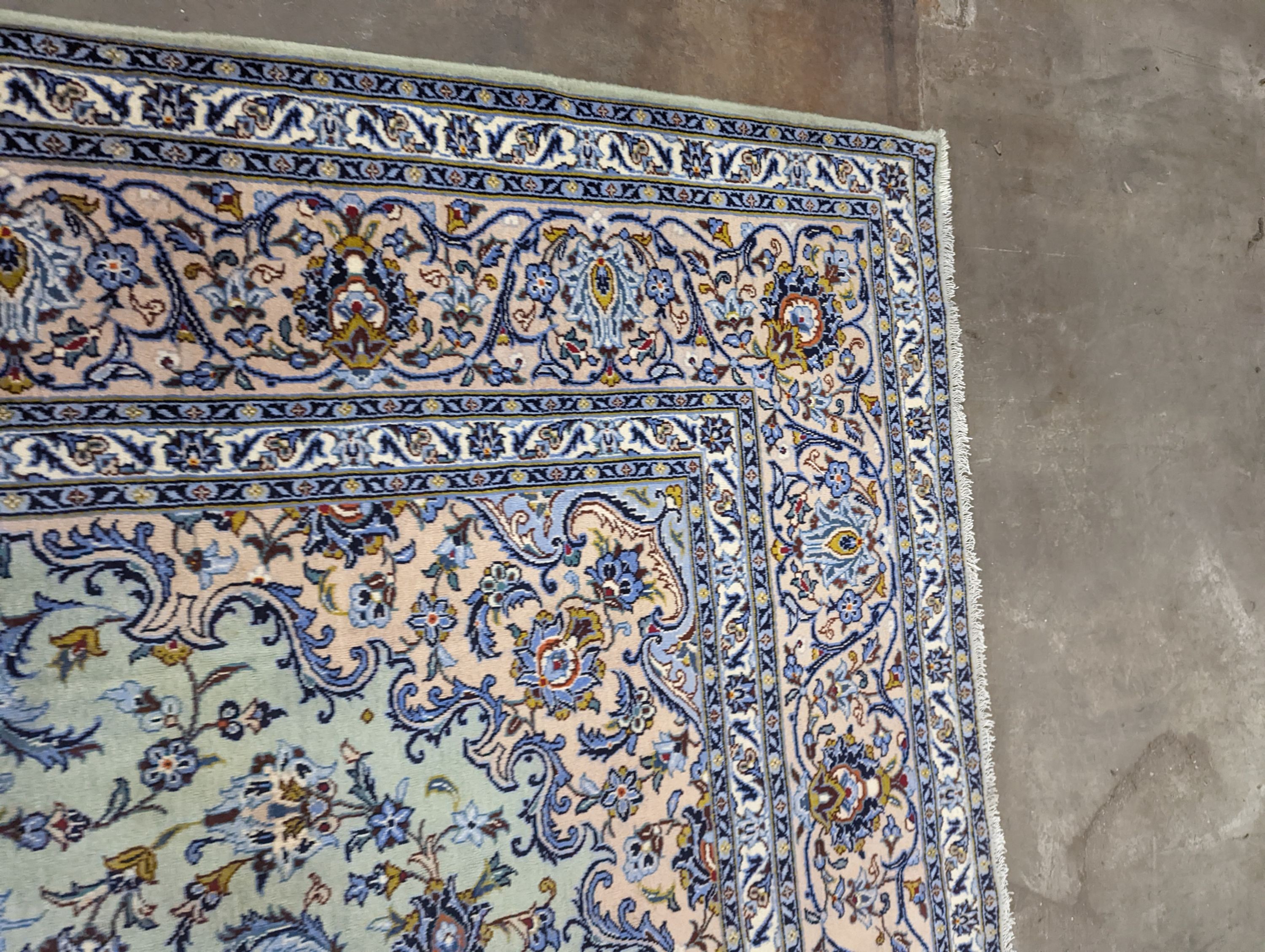 A Kashan pale green ground carpet, 410 x 296cm